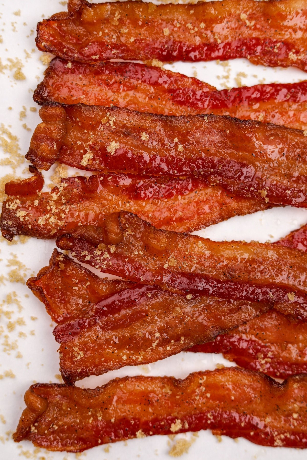 Multiple slices of candied bacon overlapping each other.