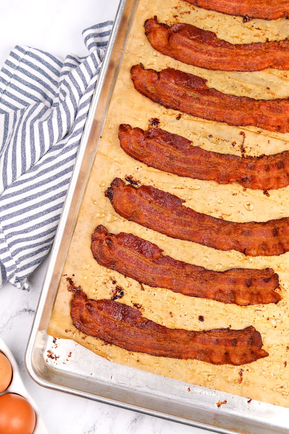 A baking sheet filled with cooked crispy bacon.
