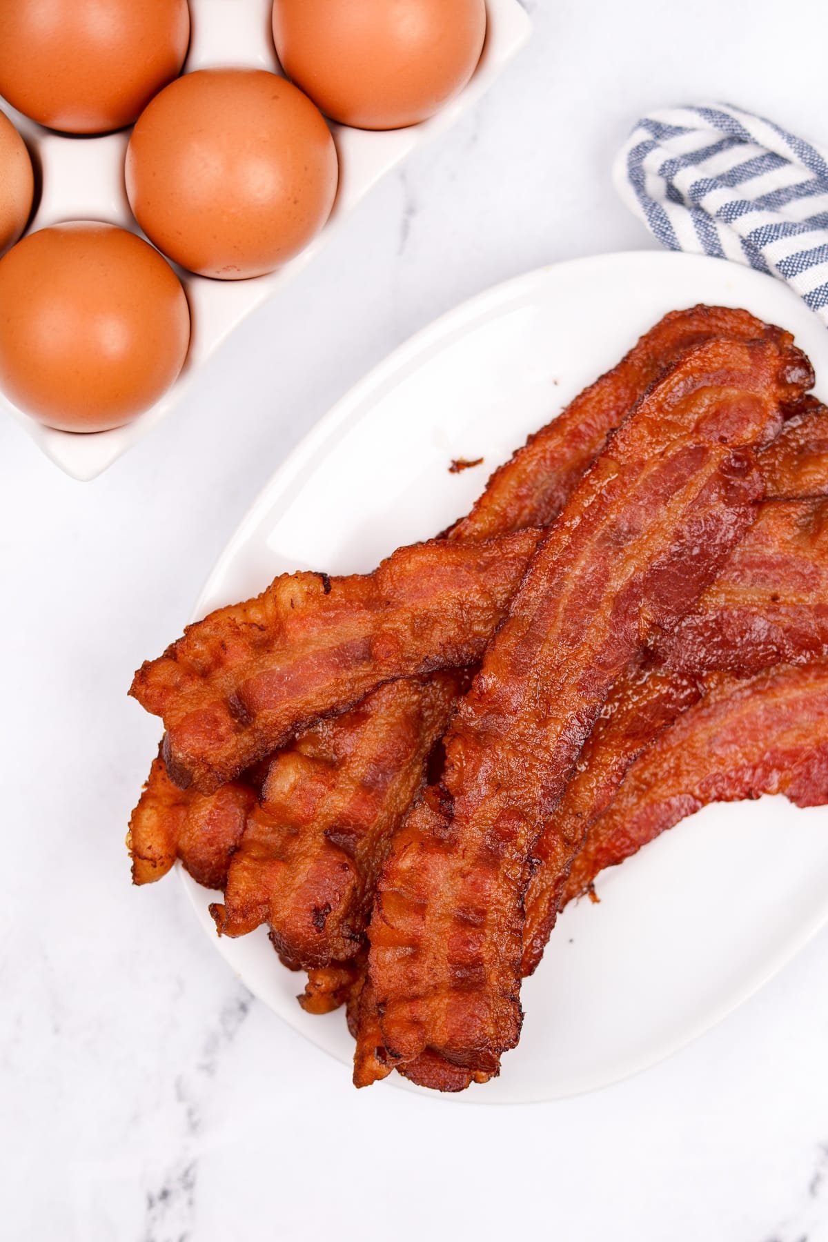 Crispy bacon on a white plate.