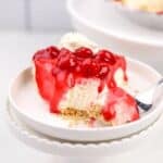 A slice of cheesecake topped with a cherry glaze.