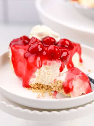 A slice of cheesecake topped with a cherry glaze.