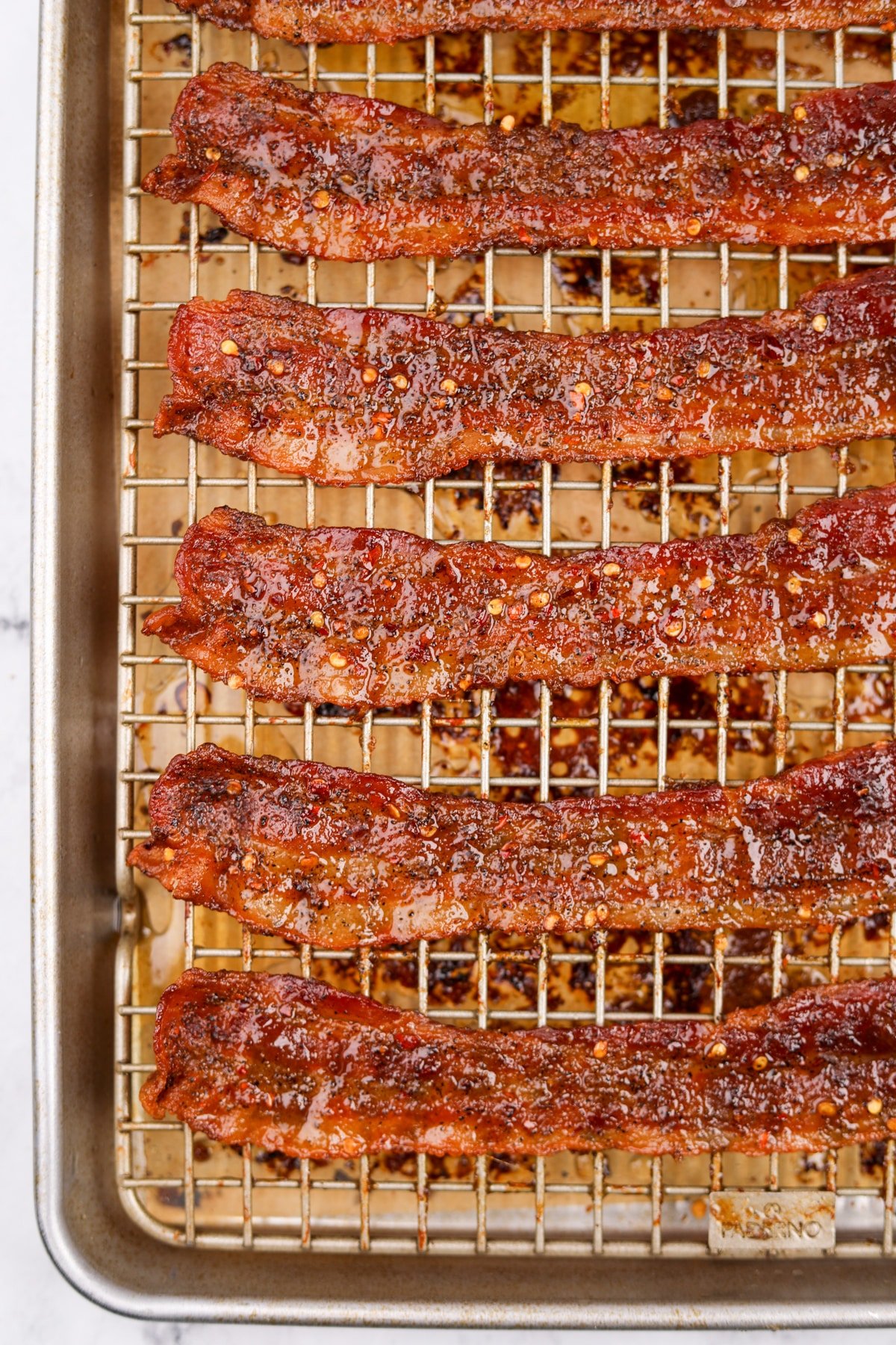 A baking rack filled with cooked crispy bacon.