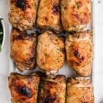 A platter of crispy baked chicken thighs.