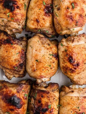 A platter of crispy baked chicken thighs.