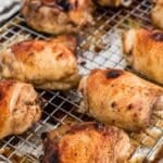 Marinated chicken thighs that have been baked on a wire rack.