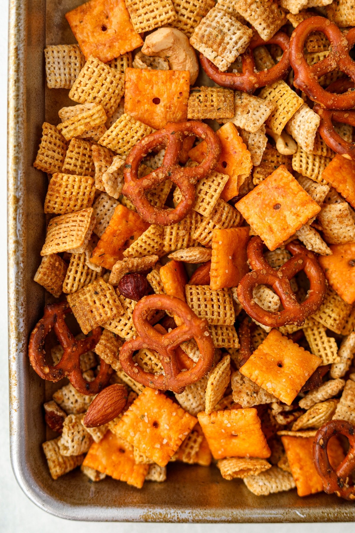 A close up of a baking sheet filled with a homemade snack mix.