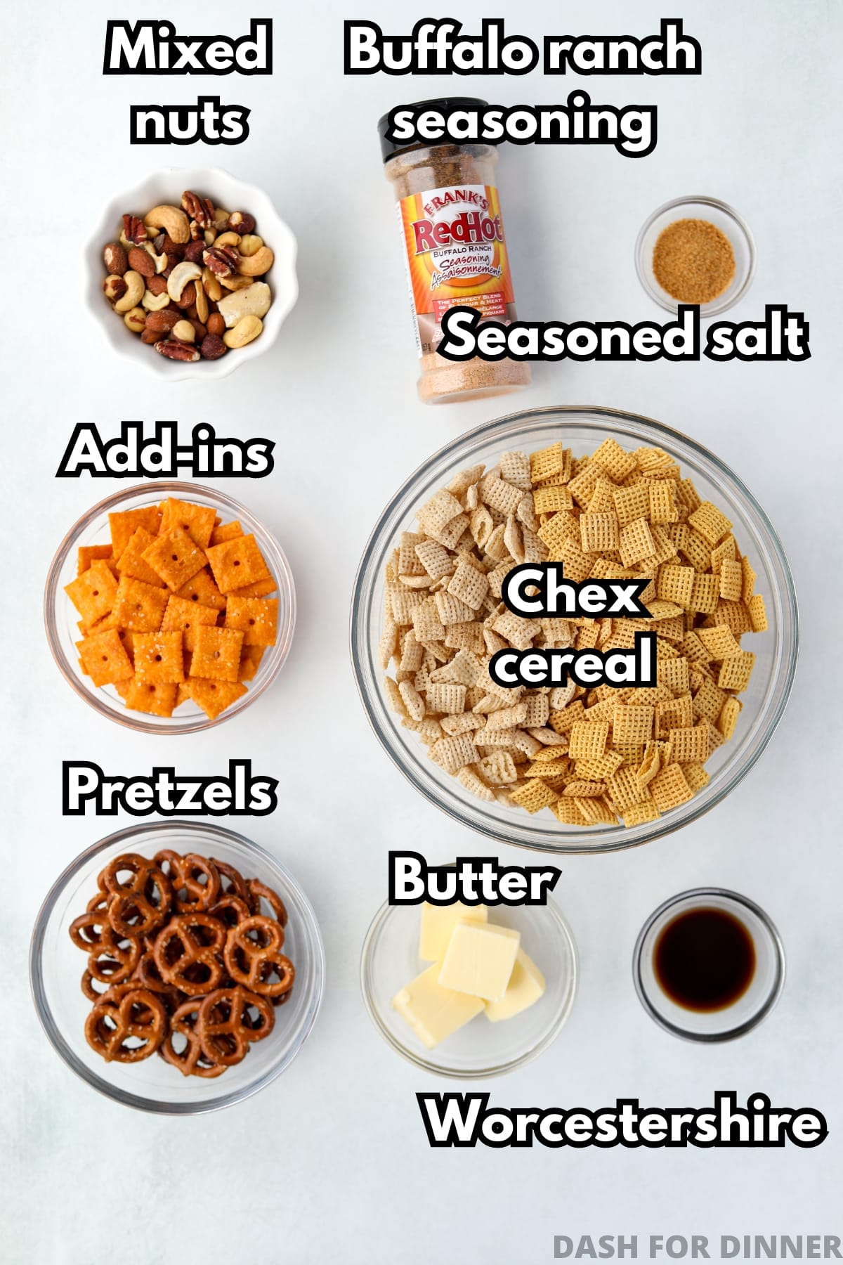 The ingredients needed to make spicy chex mix, including Chex cereal, pretzels, nuts, and seasoning.