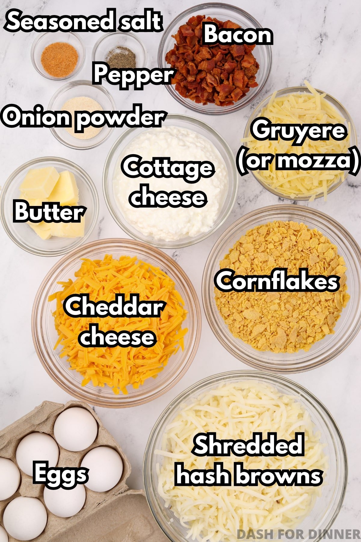 The ingredients needed to make a breakfast casserole with shredded hash browns, including cheese, bacon, eggs, cottage cheese, and butter.