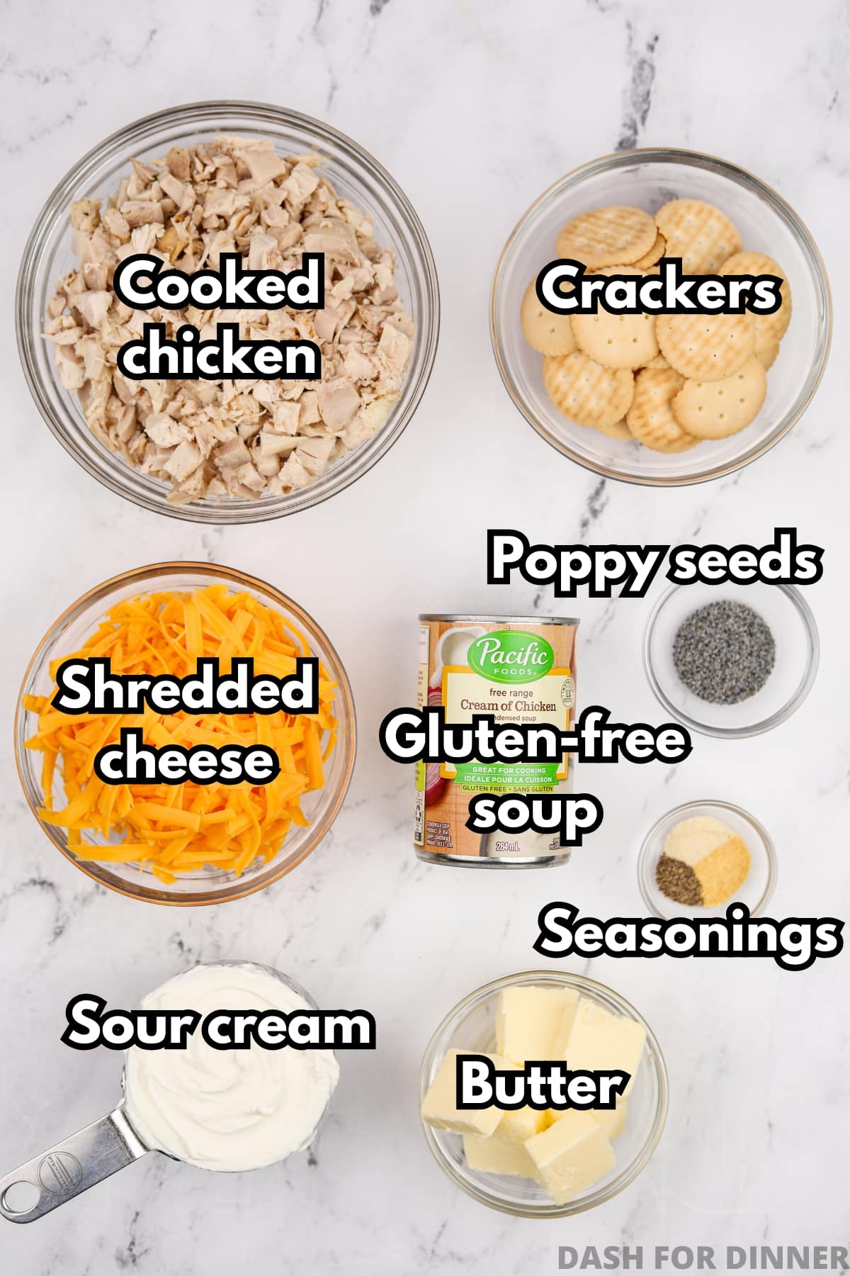 The ingredients needed to make chicken casserole, including cheese, crackers, butter, and cooked chicken.