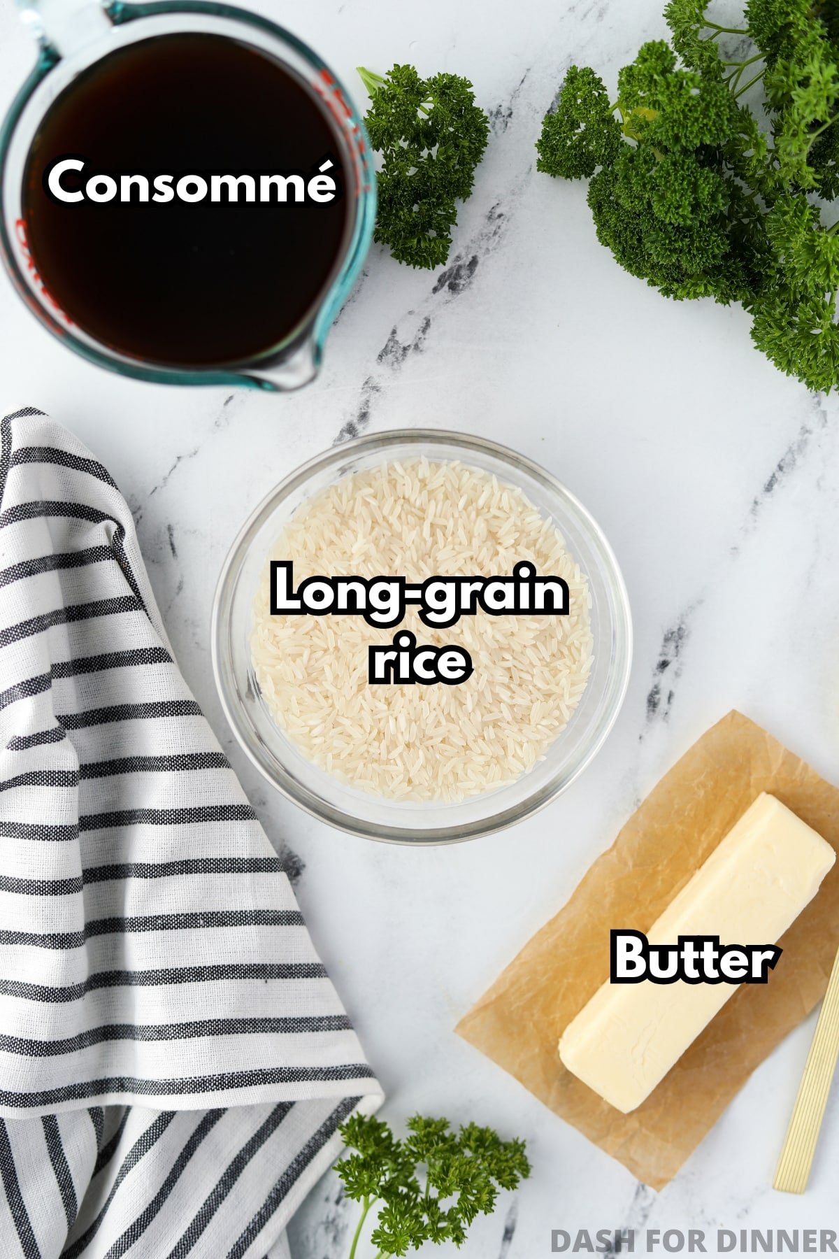 A bowl of rice, a measuring cup of consomme, and a stick of butter.