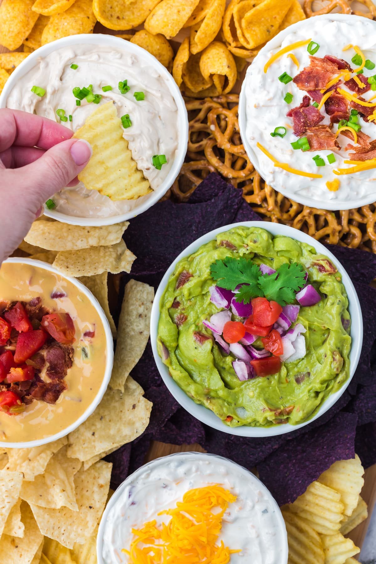 Dipping a crinkle chip in a bowl of french onion dip.