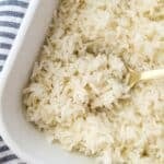 Scooping cooked rice with a spoon.