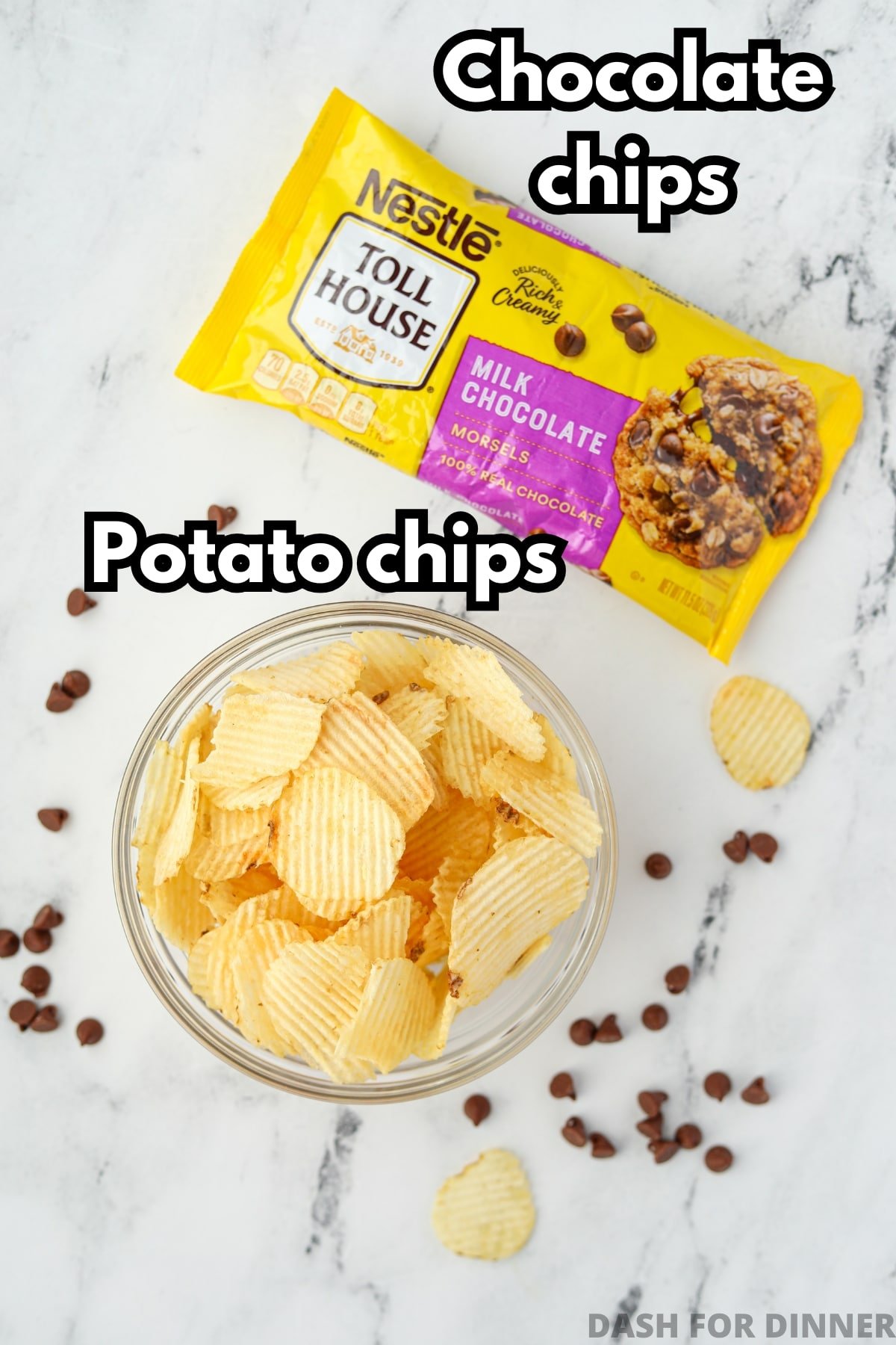 A bag of chocolate chips and a bowl of potato chips on a white marble surface.