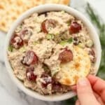 Dipping a cracker into a bowl of tuna salad.