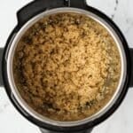 An Instant Pot with cooked quinoa in the insert.