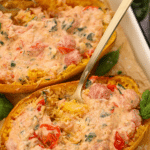 A spaghetti squash shell filled with shredded squash and a creamy tomato sauce.