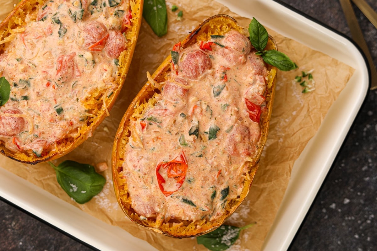 Half of a squash filled with a tomato, basil, and Boursin cheese sauce.