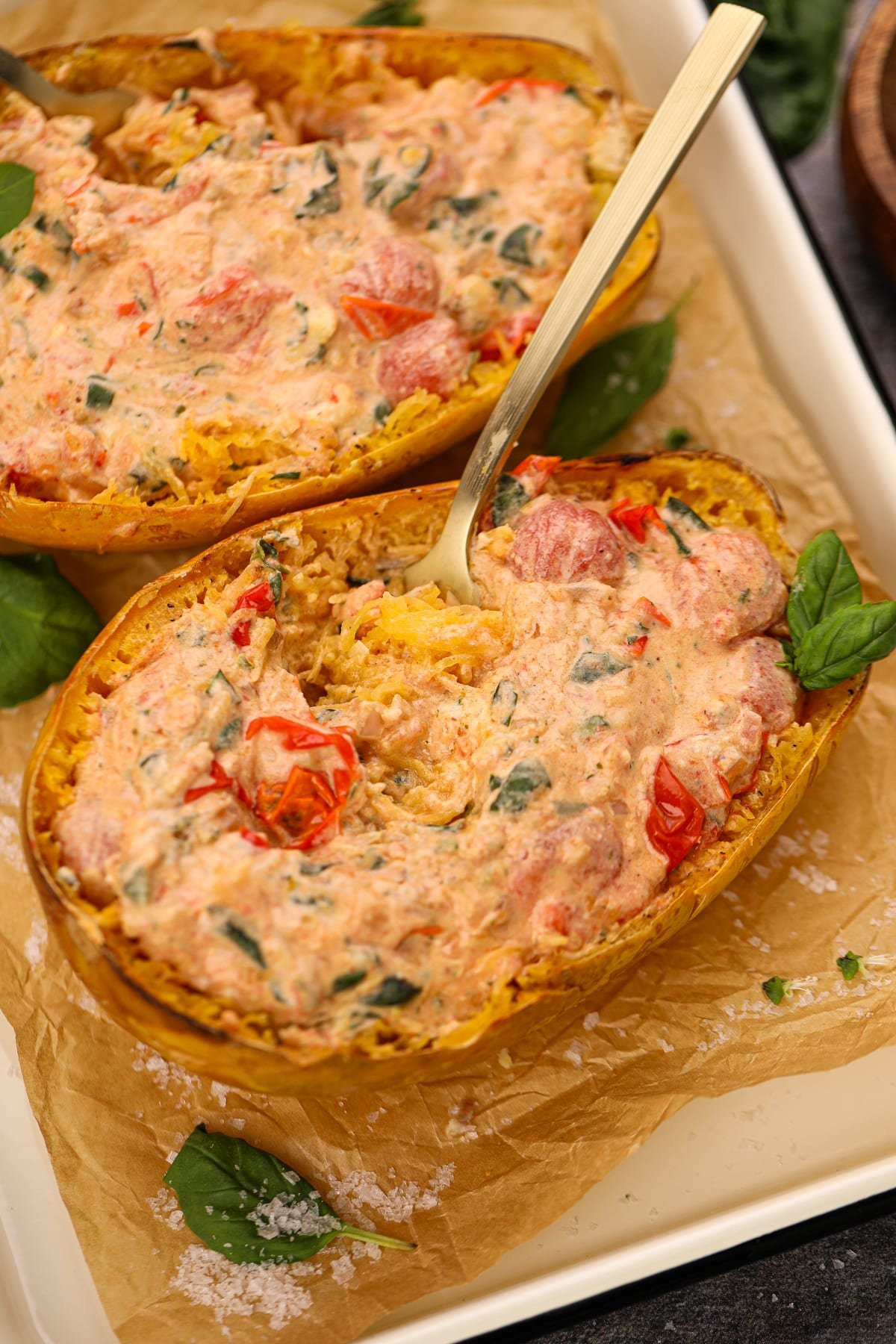 A fork twirling the insides of a stuffed spaghetti squash.