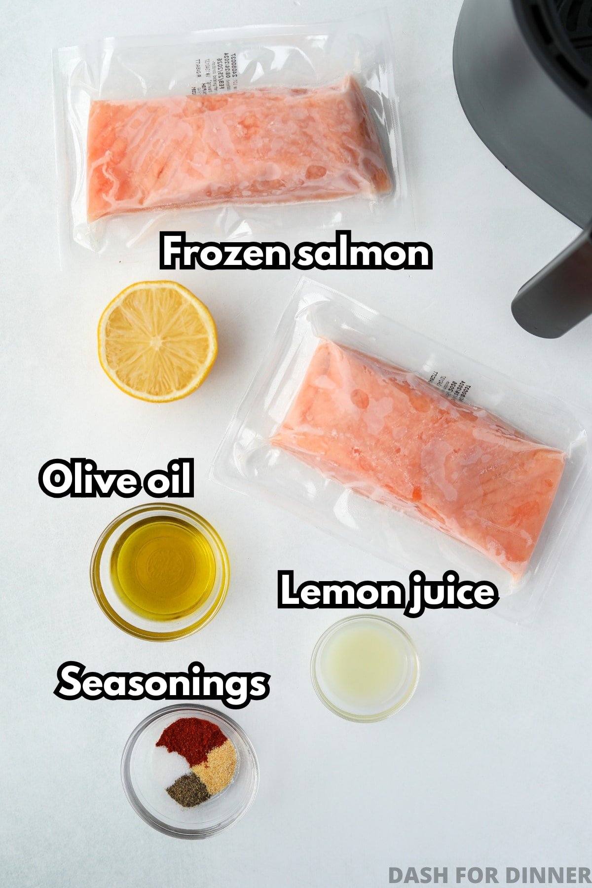 Two fillets of frozen salmon that are vacuum packed, plus olive oil, lemon, and seasonings.
