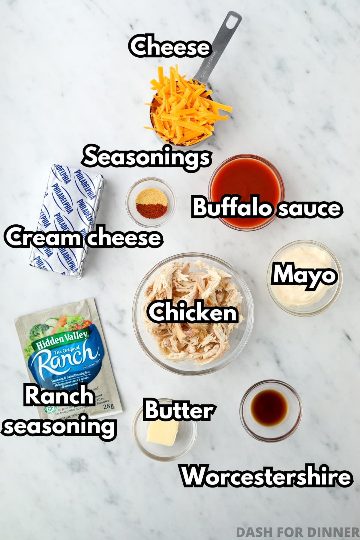 The ingredients needed to make buffalo chicken dip, including cream cheese, chicken, cheese, and buffalo sauce.