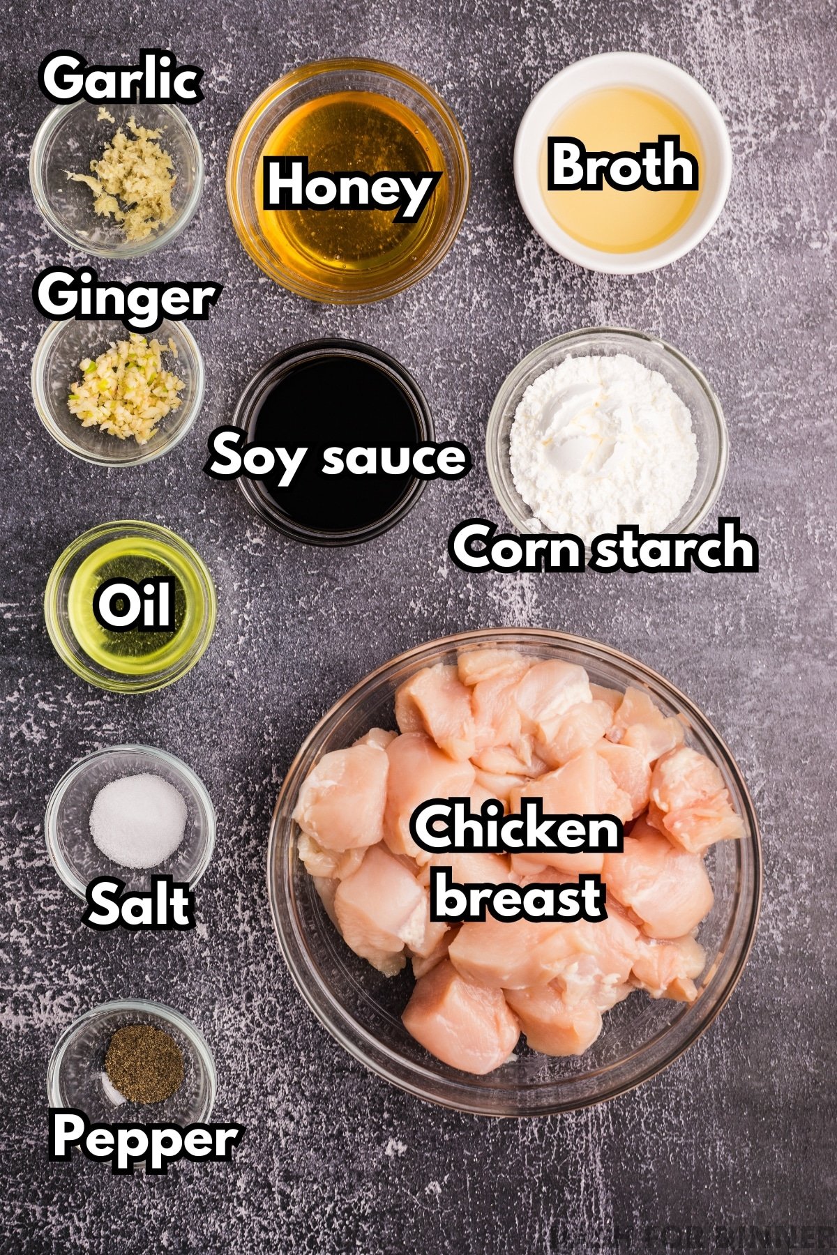 The ingredients needed to make honey ginger chicken, including soy sauce, cornstarch, cubed chicken breast, and ginger. 