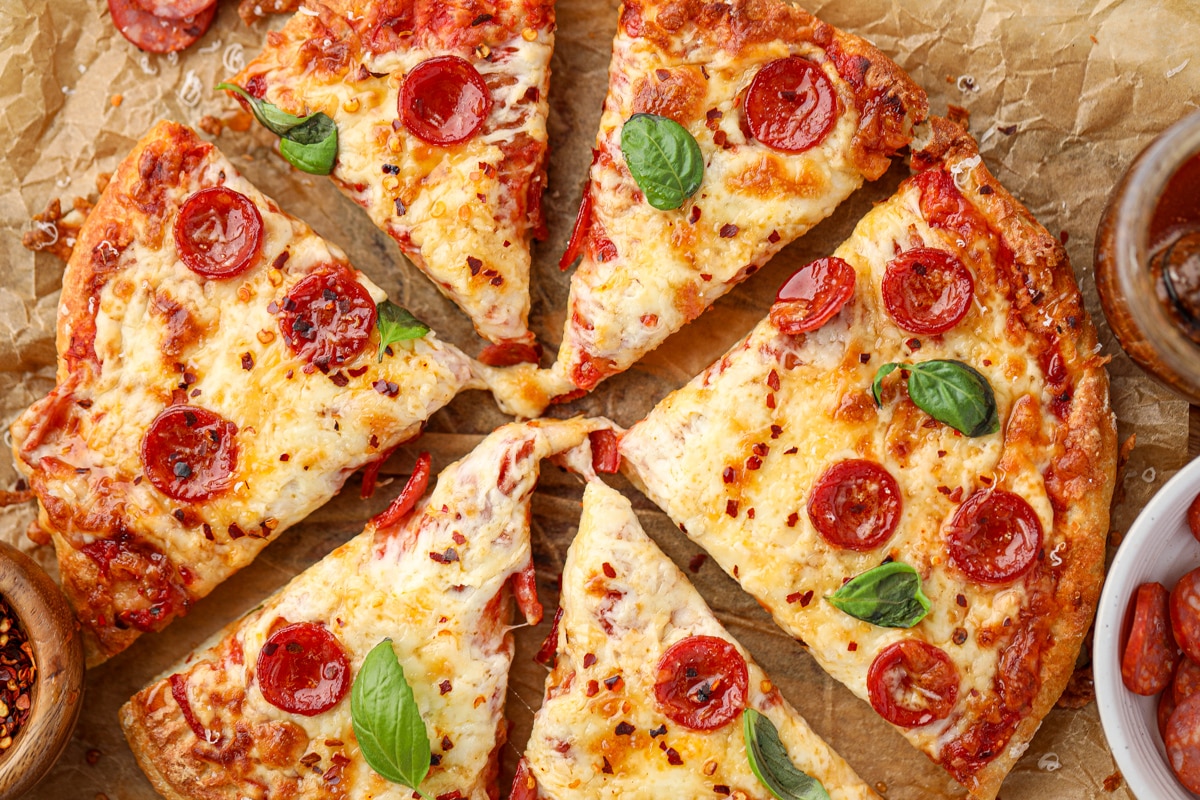A round pizza sliced into 6 uneven pieces.