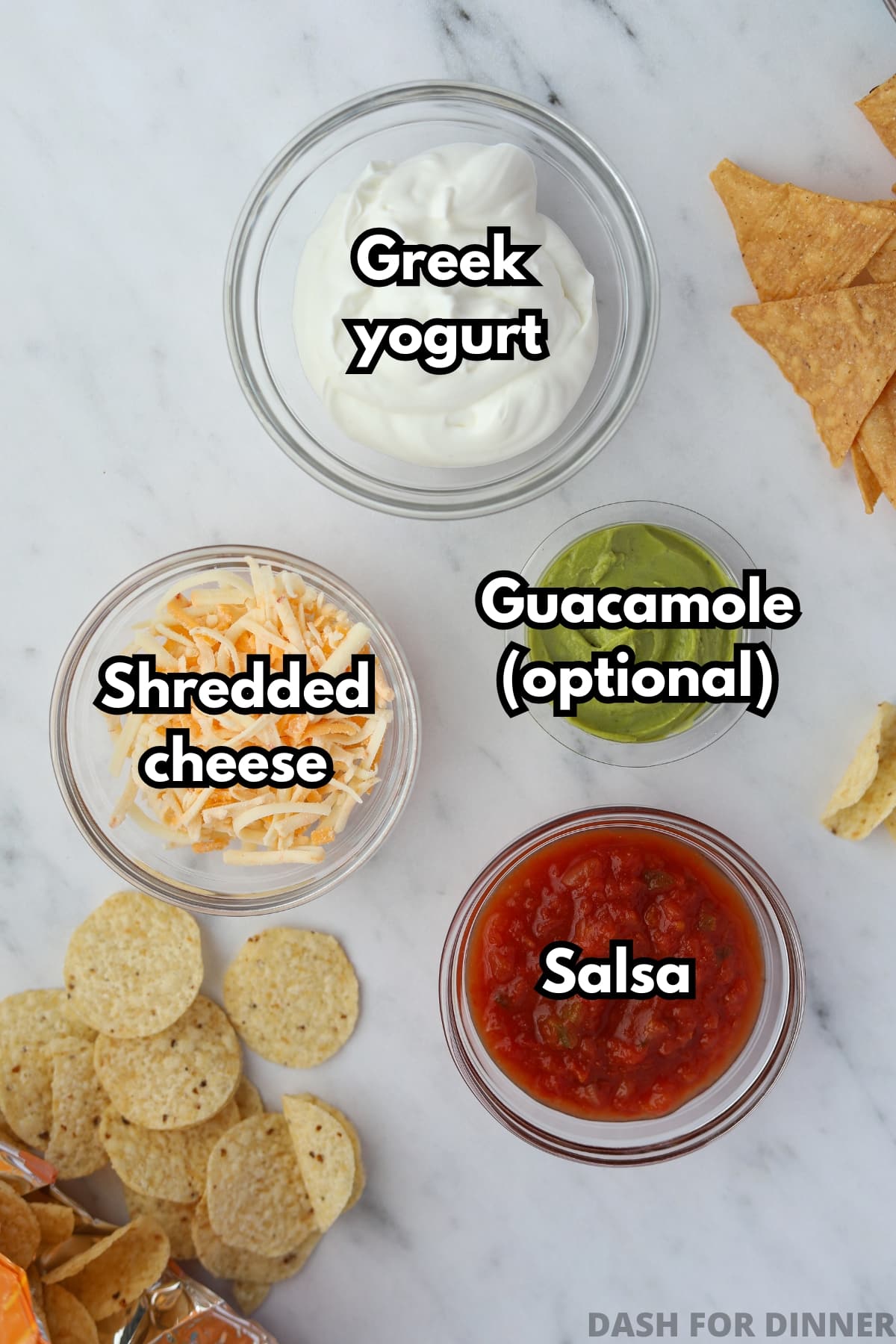The ingredients needed to make layered protein dip: Greek yogurt, salsa, shredded cheese, and guacamole.
