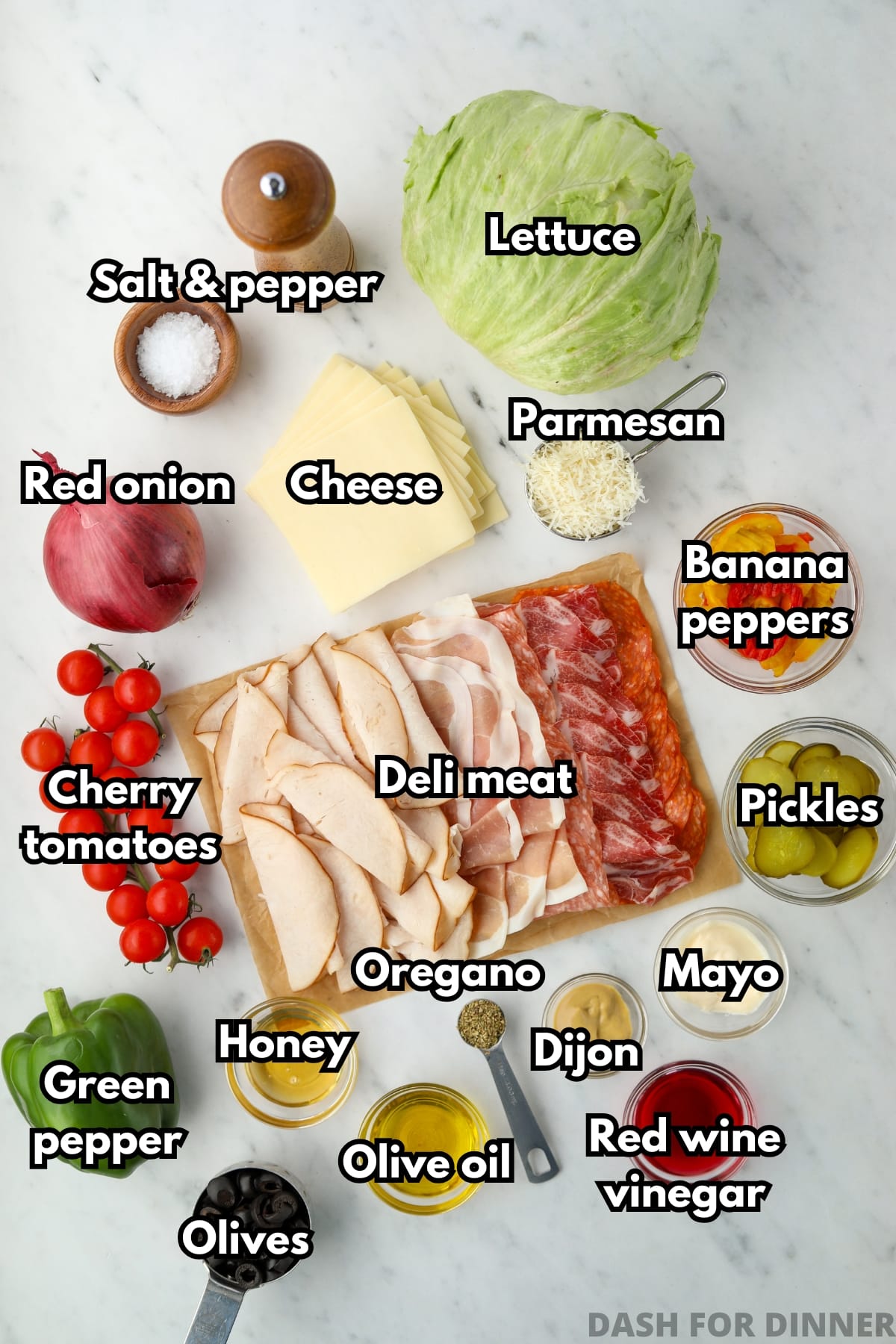 An overhead photo of ingredients, including deli meat, lettuce, and vegetables.