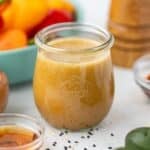 A small jar filled with homemade ginger sesame dressing.