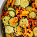 A large bowl filled with cucumber and bell pepper salad.