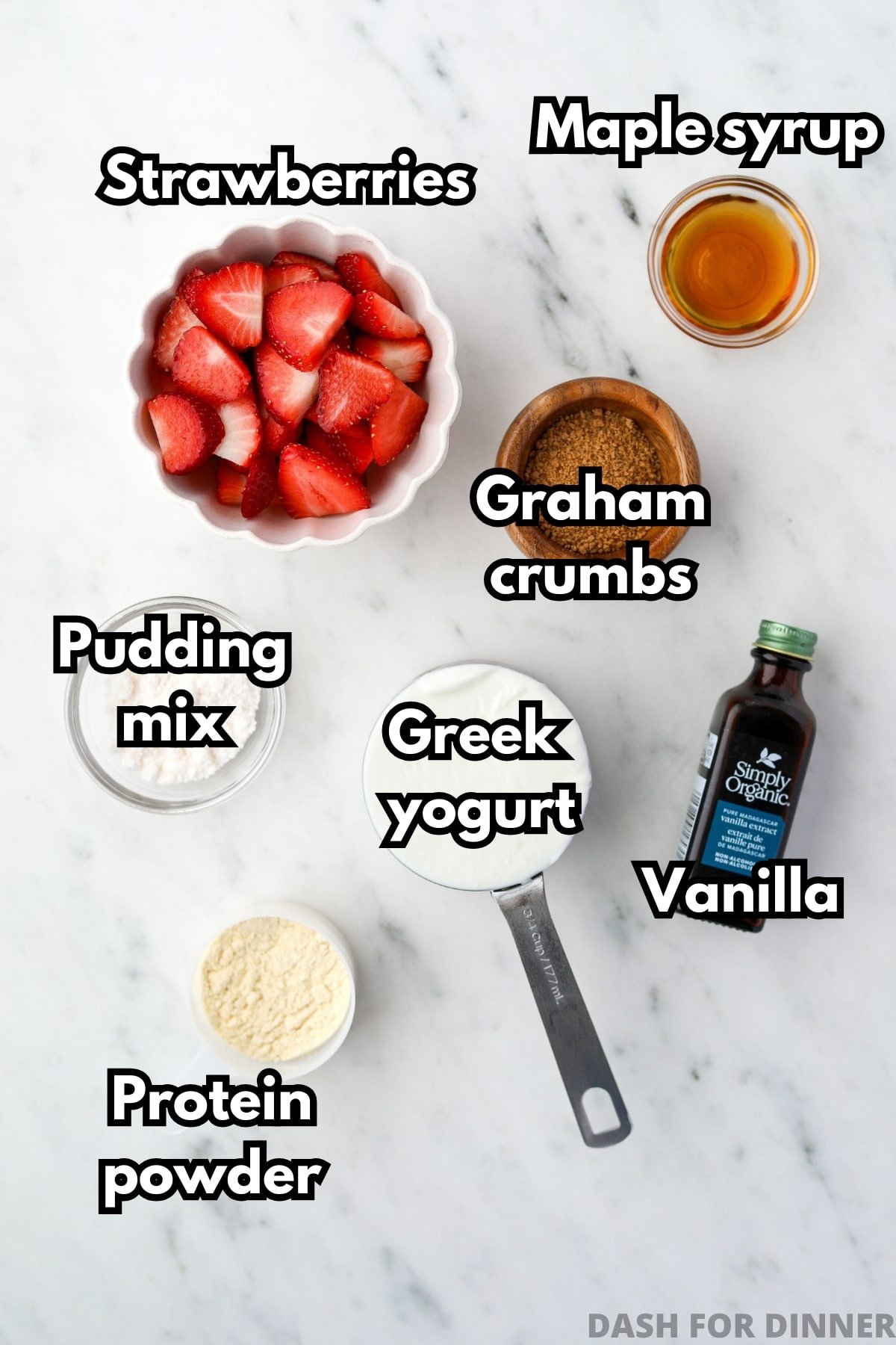 A bowl of sliced strawberries, some greek yogurt, maple syrup, and several other ingredients.