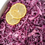 A bowl filled with purple cabbage salad.