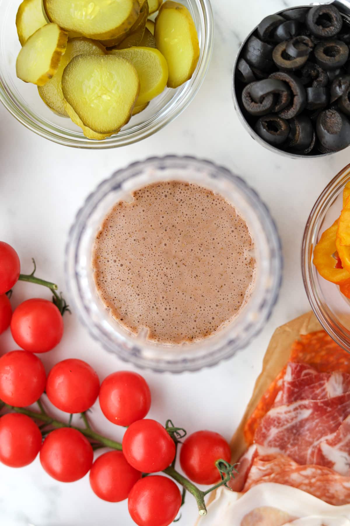 A small jar blender filled with creamy Italian sub dressing.