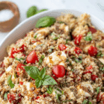 A large serving bowl filled with quinoa salad.