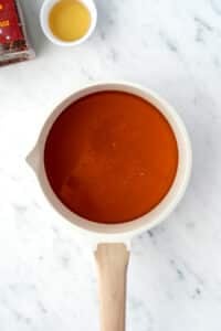 A small saucepan with honey inside.