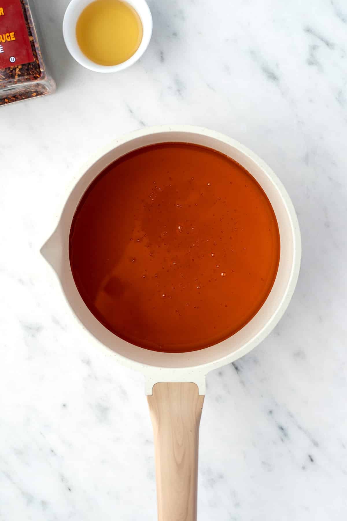 A small saucepan with honey inside.