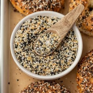 A small bowl of everything bagel seasoning with a small wooden spoon.
