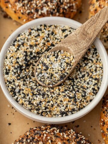 A small bowl of everything bagel seasoning with a small wooden spoon.