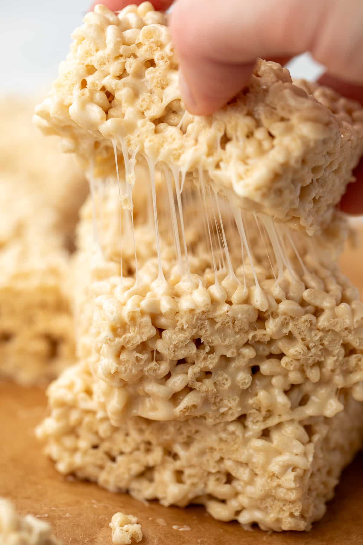 Pulling a cereal treat from on top of a stack.