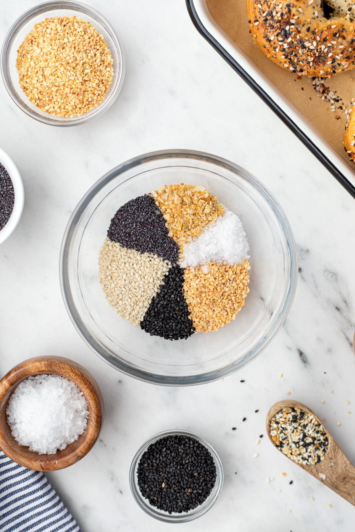 A small bowl with a variety of seasonings laid out in a circular fashion.