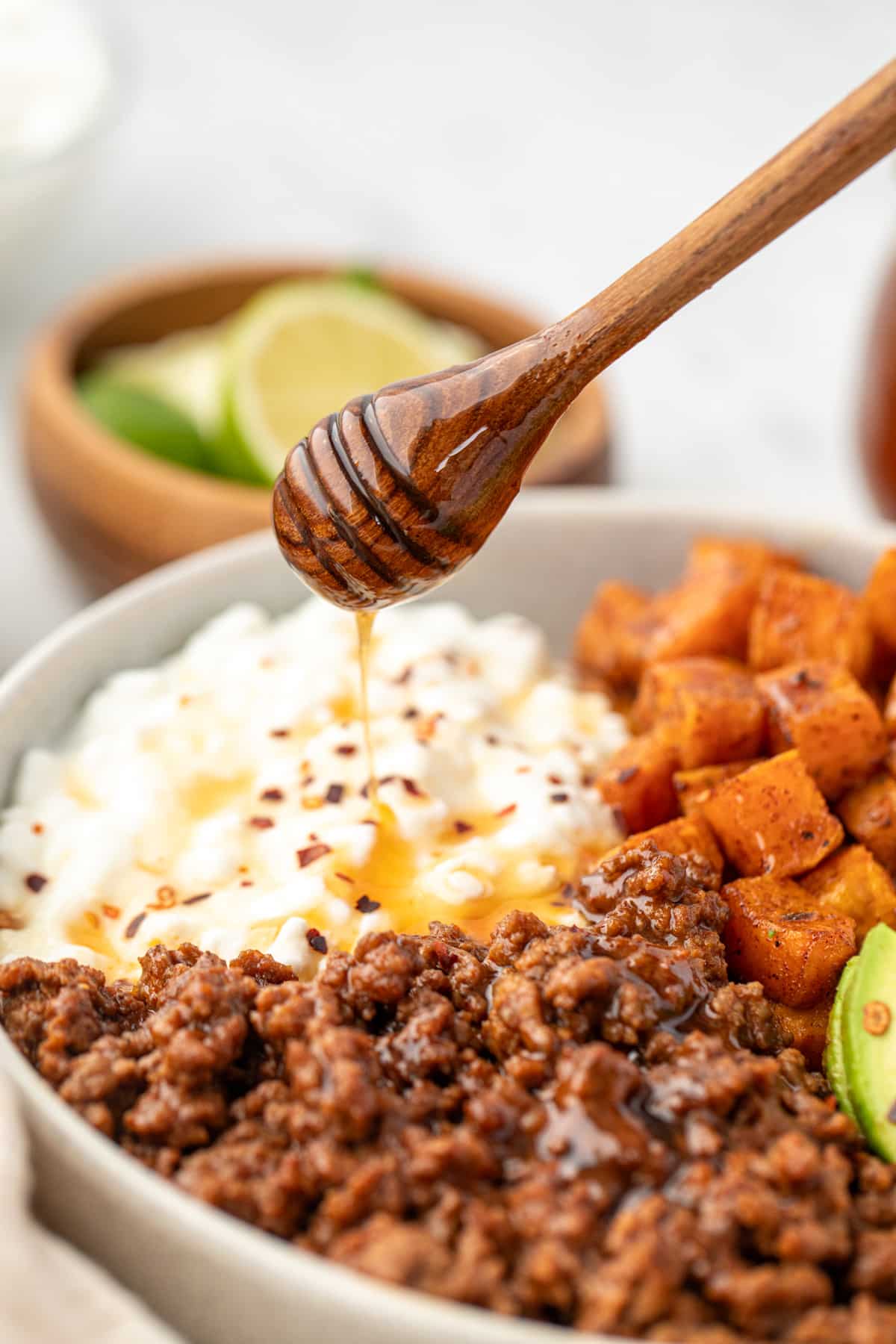 Drizzling honey on top of cottage cheese and seasoned ground beef.