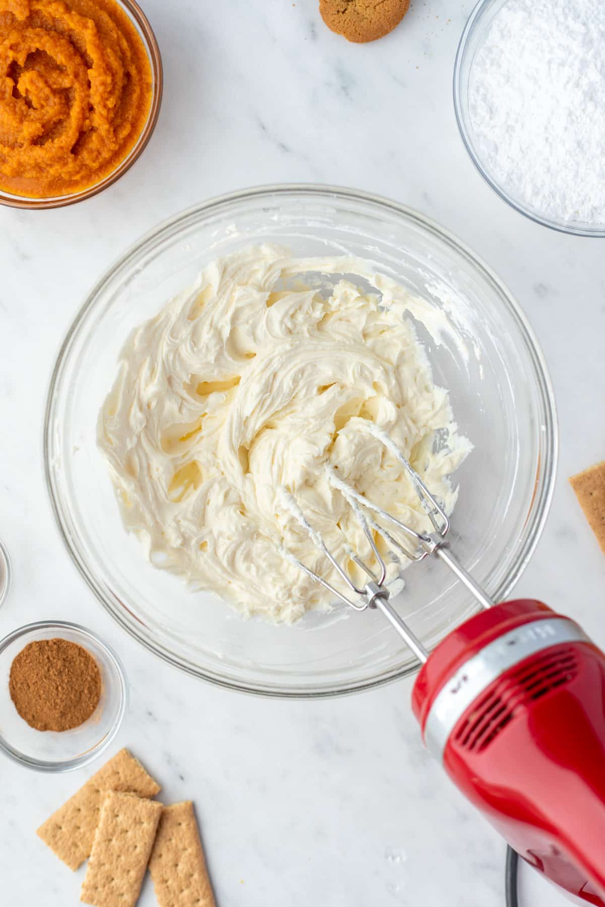 A bowl of whipped cream cheese on a white counter.