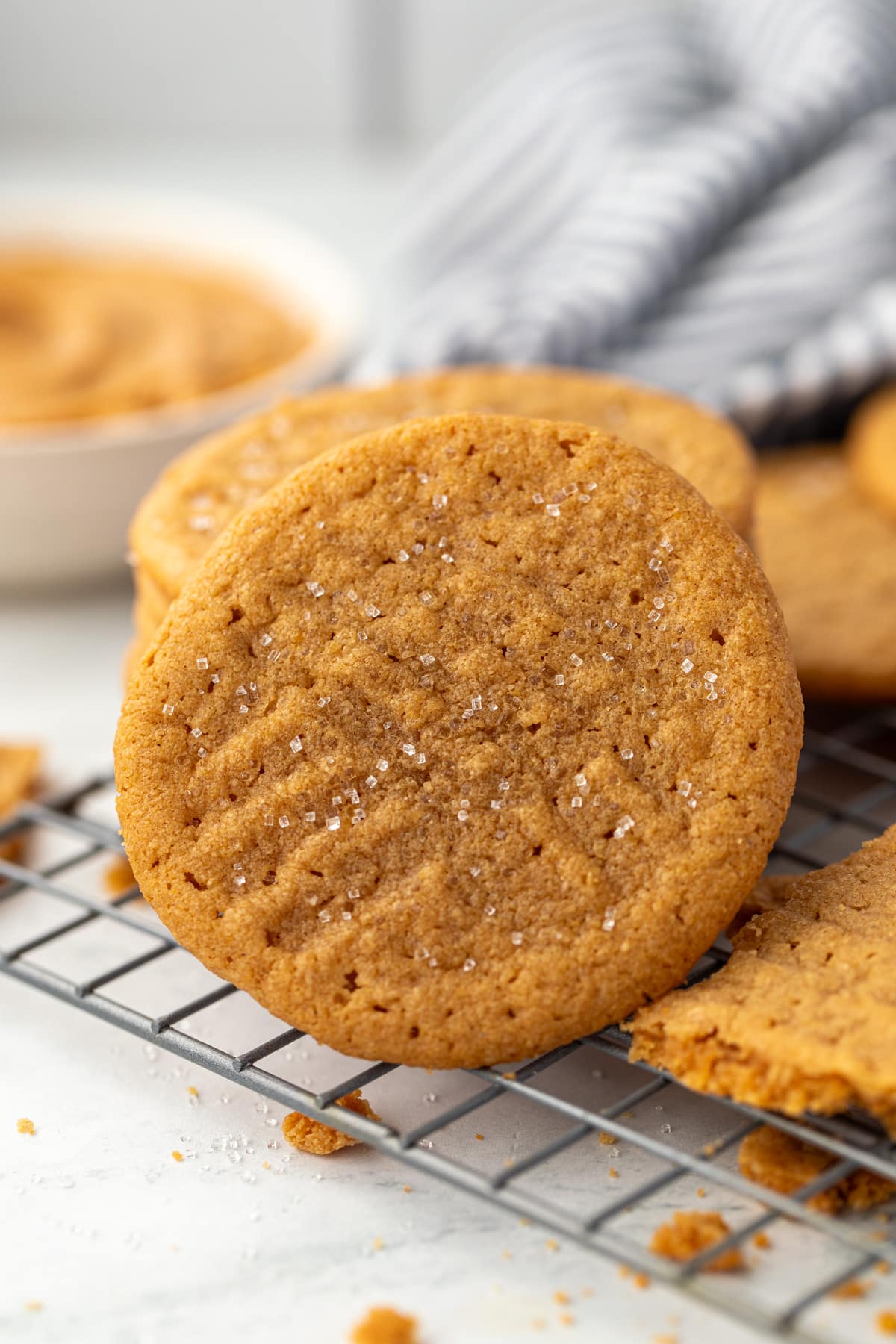 A stack of peanut butter cookies on a wire rack.