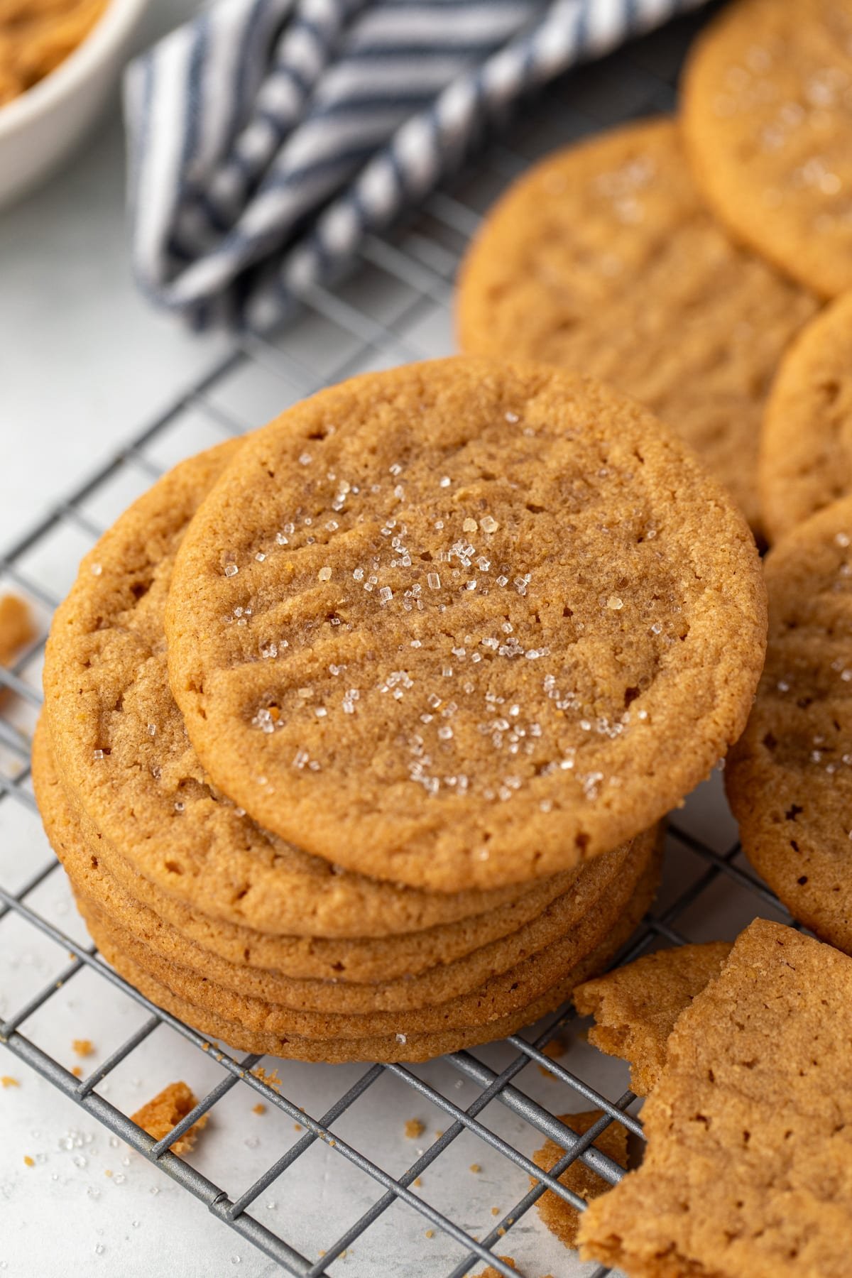 A stack of peanut butter cookies on a wire rack.