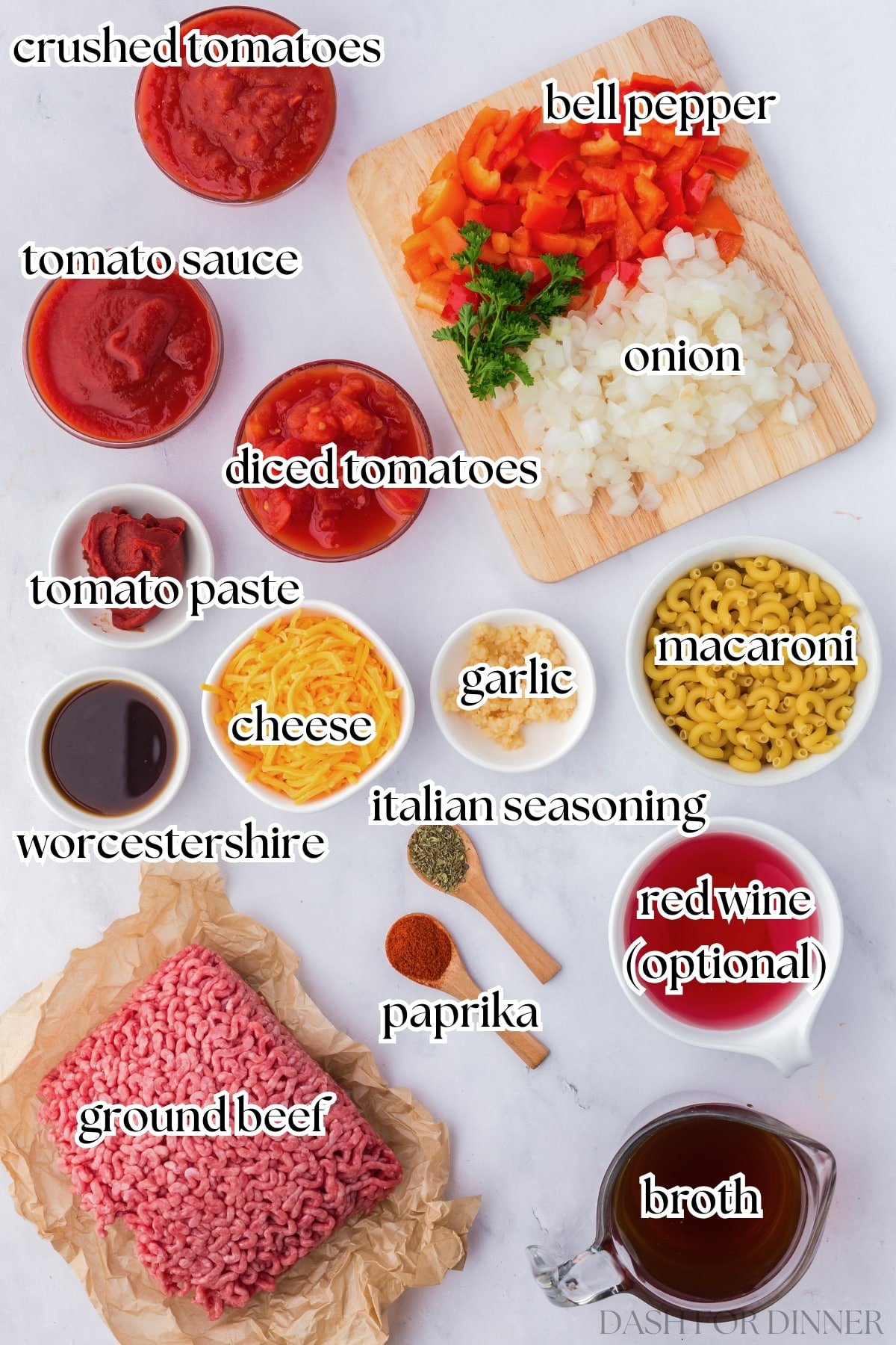 The ingredients to make American goulash (or chop suey), including beef, cheese, onion, diced tomatoes, and elbow macaroni.