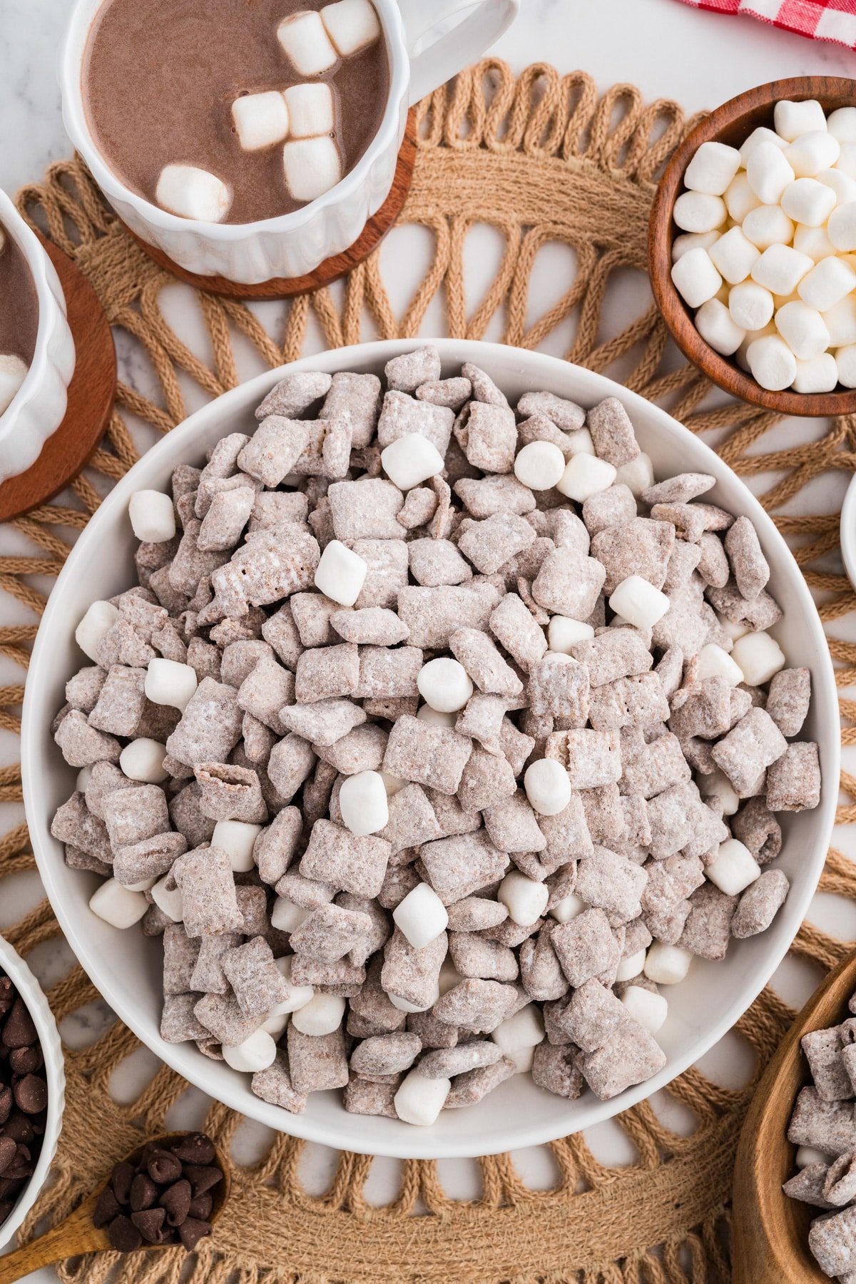 A bowl of muddy buddy chex mix in a bowl with mini marshmallows.