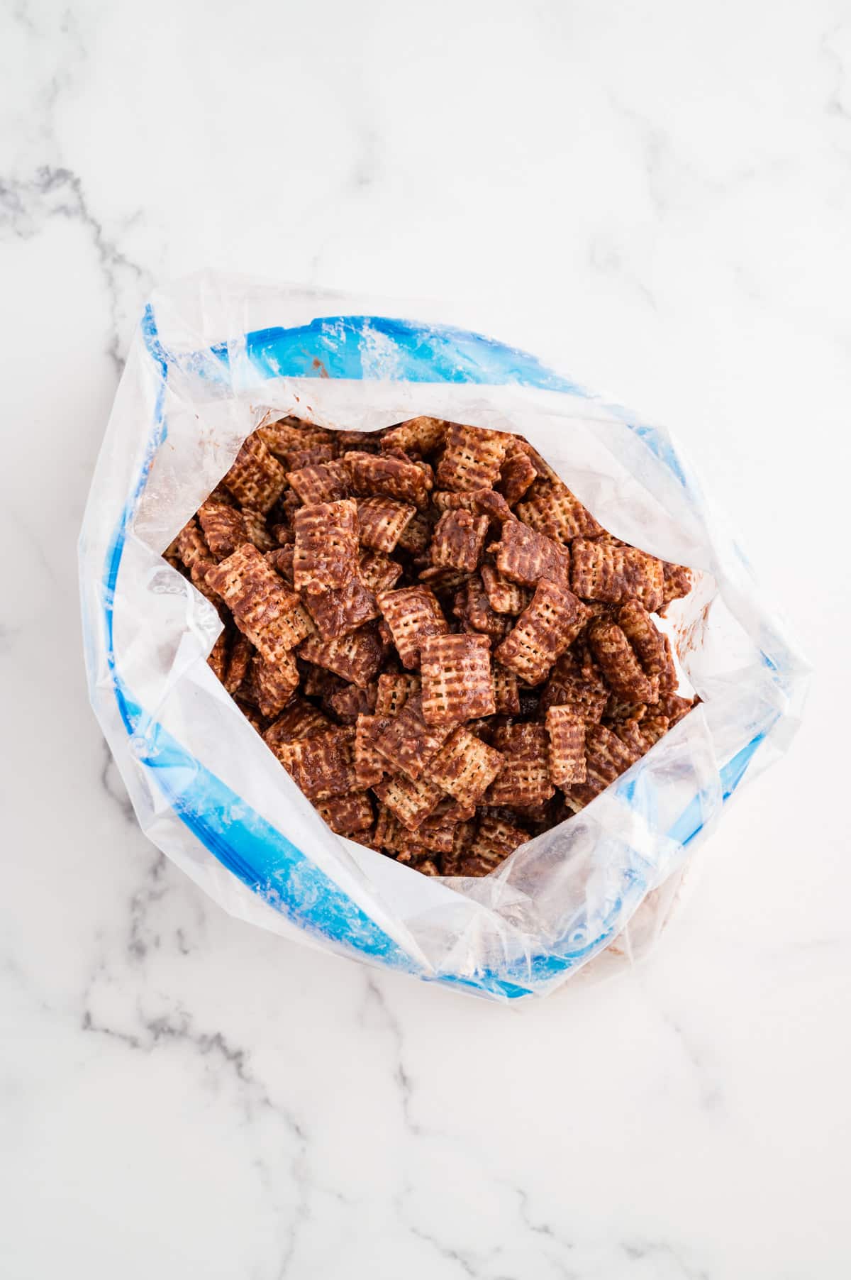 A bag filled with chocolate-coated Chex cereal.