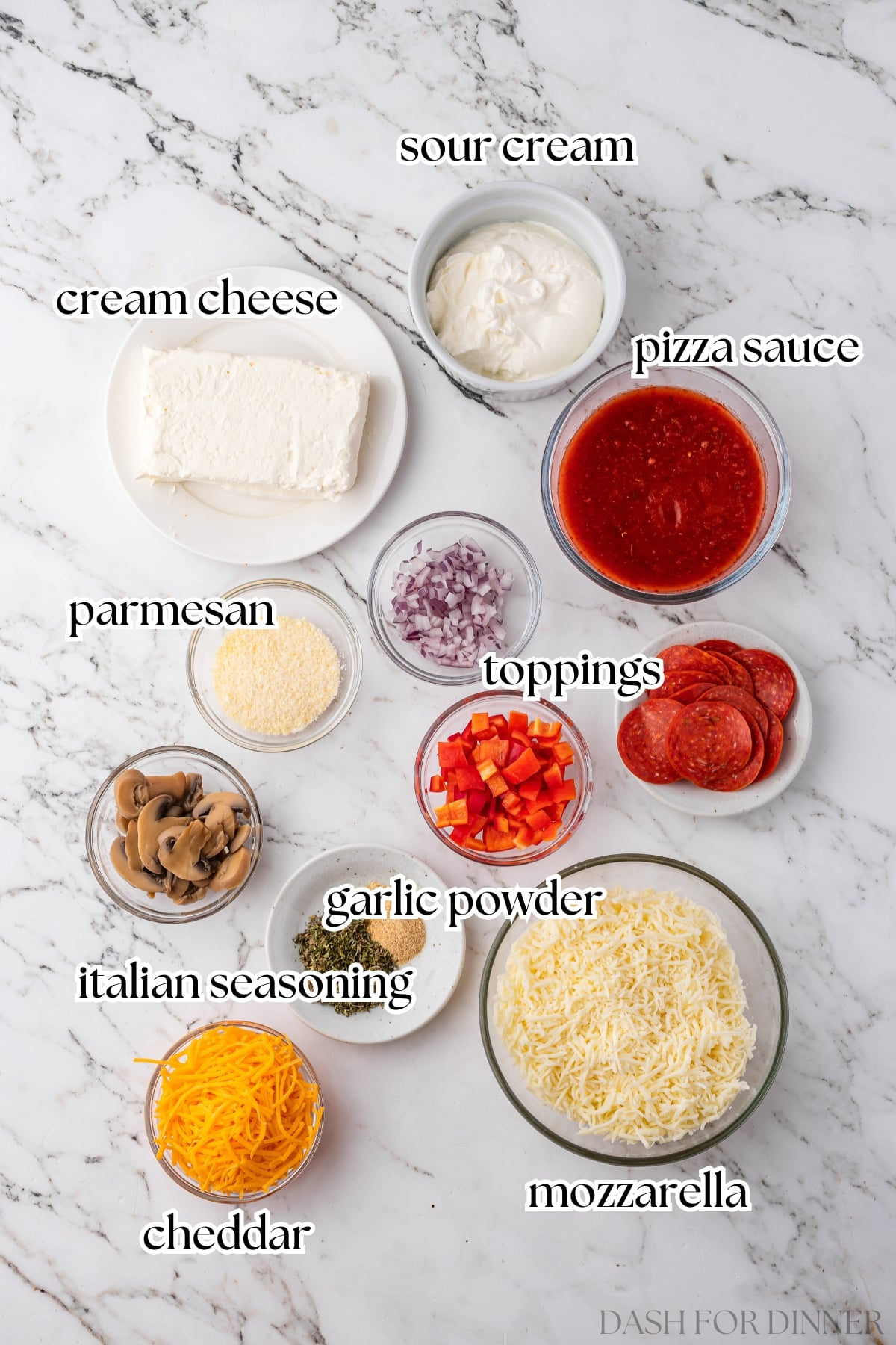 The ingredients needed to make pizza dip, including sour cream, cream cheese, pizza sauce, and cheese.
