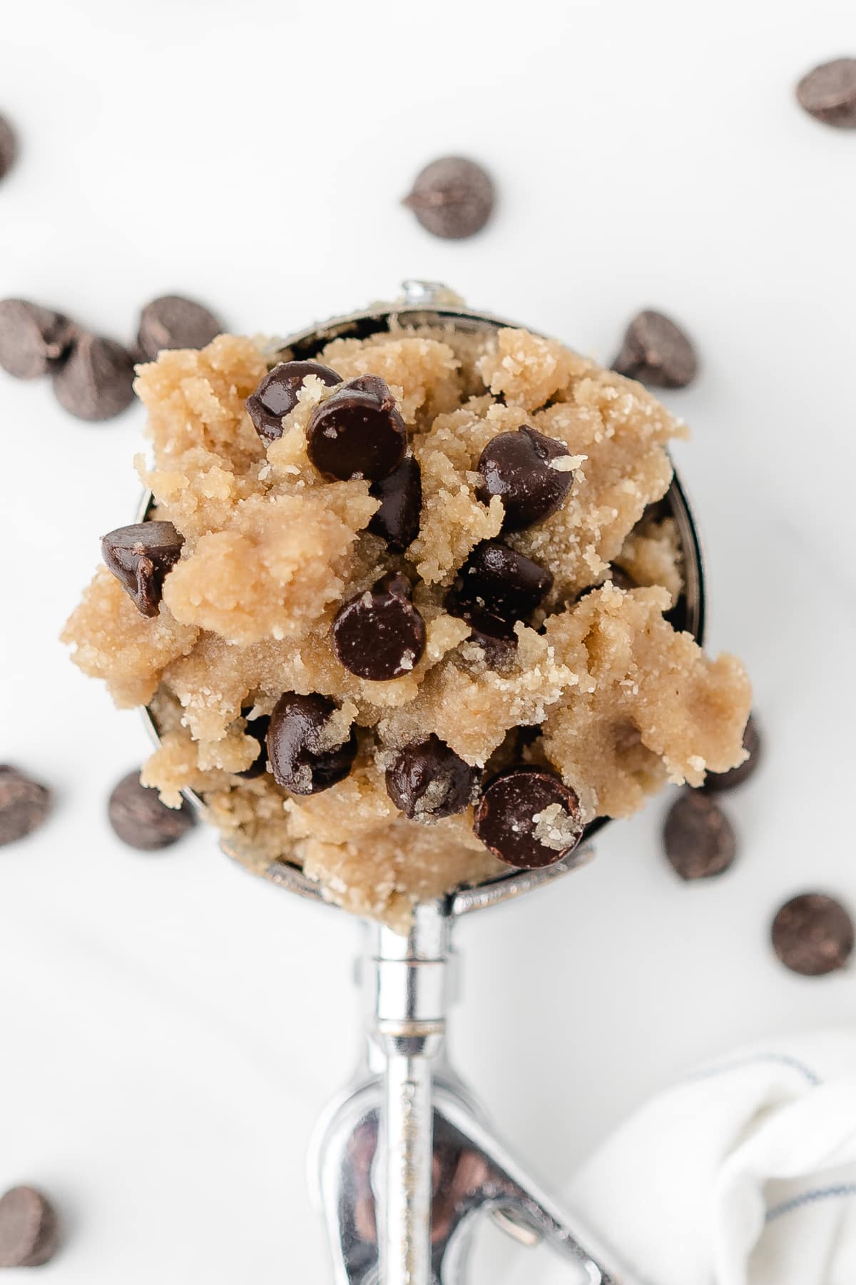 A scoop of cookie dough filled with chocolate chips.`
