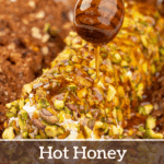 Drizzling honey on a pistachio-coated goat cheese log.